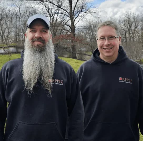 Two Apple Fitness Equipment team members in branded hoodies