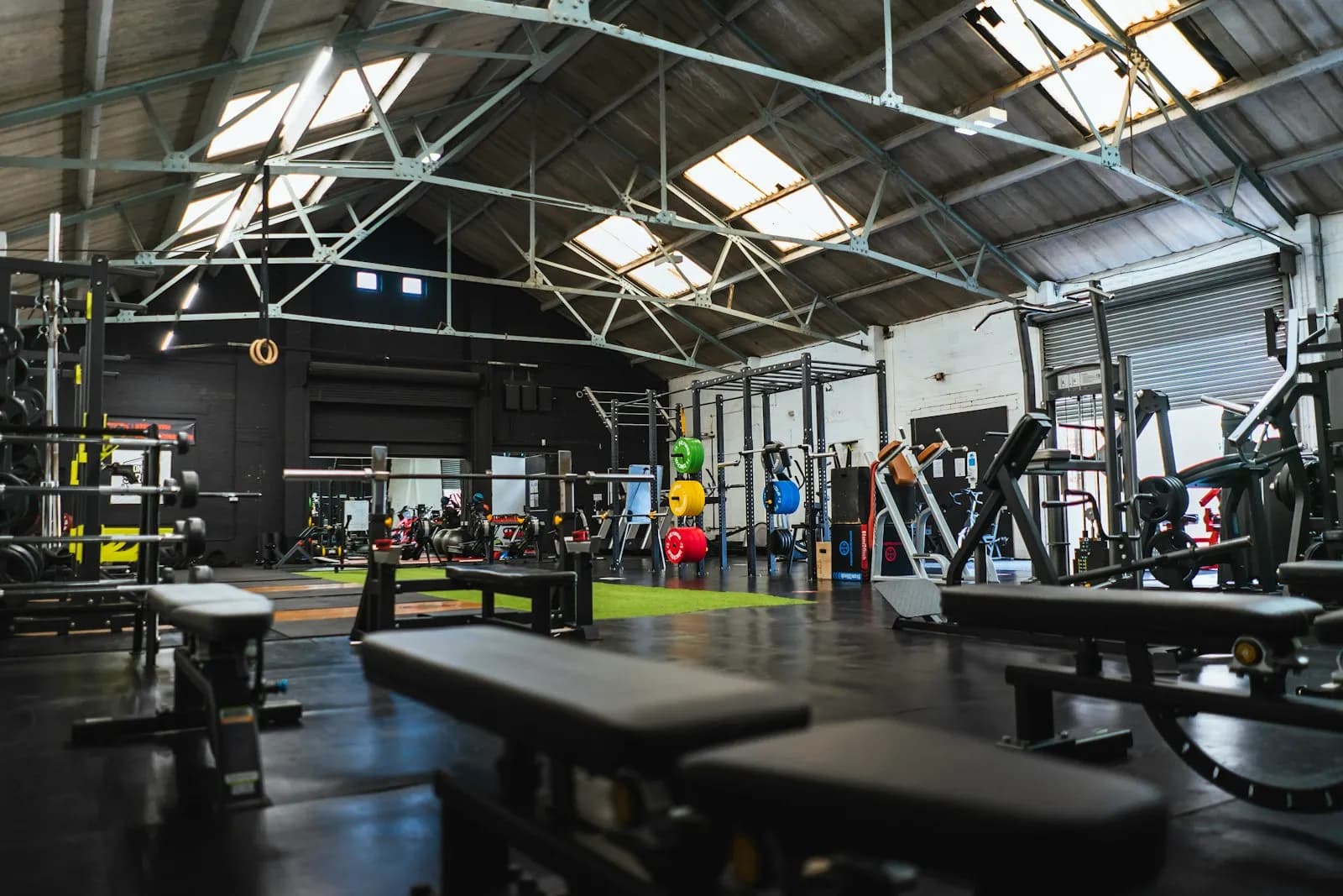 Large industrial gym full of benches and strength equipment
